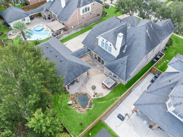 an aerial view of a house with a garden and a car parked