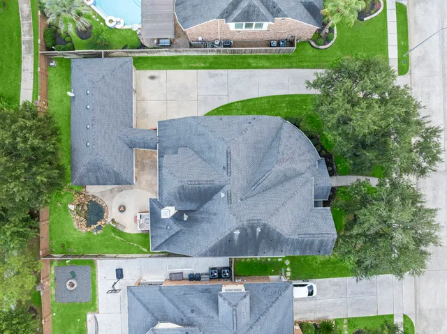 an aerial view of a house with a yard