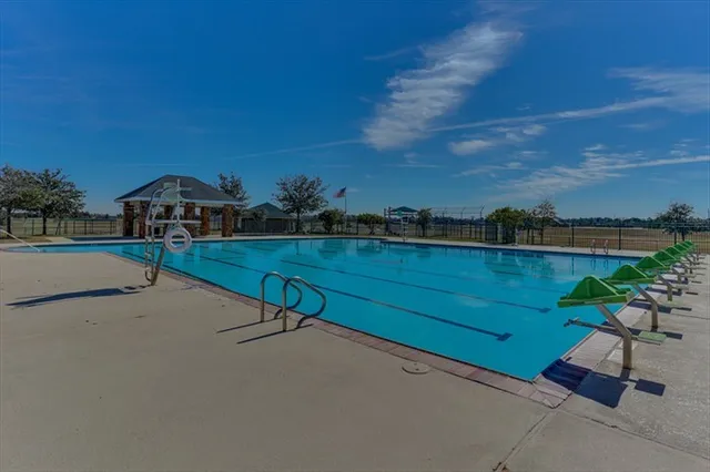 a view of a patio with a table and chairs under an umbrella
