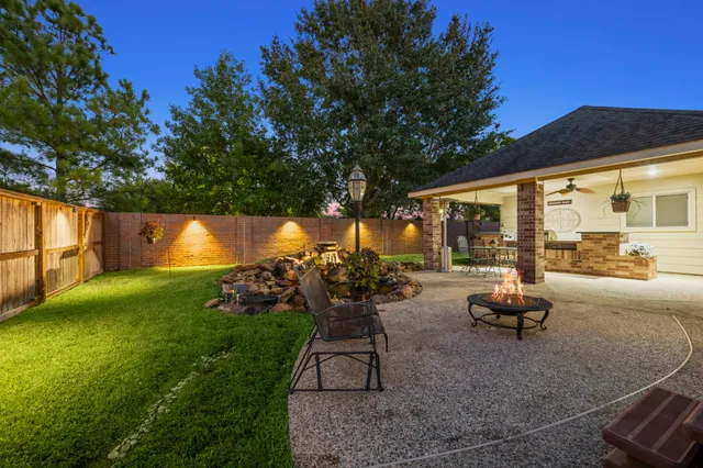 a backyard of a house with table and chairs