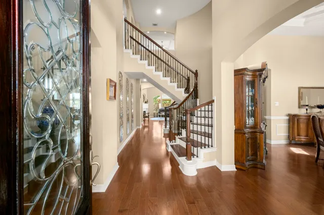 a hallway and a livingroom with furniture stairs