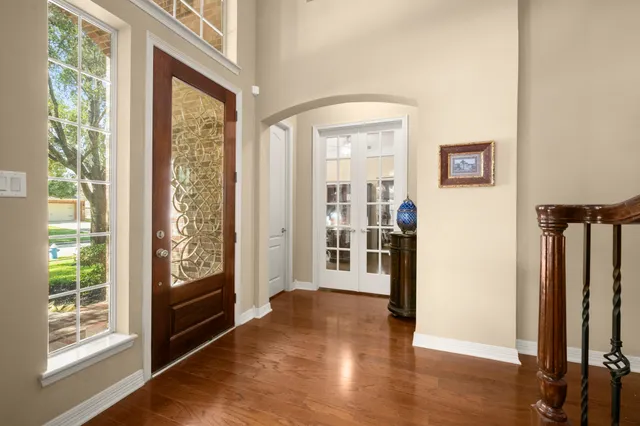 a view of a livingroom with wooden floor and a window