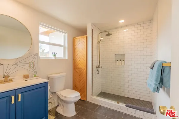 a bathroom with a toilet a sink and shower