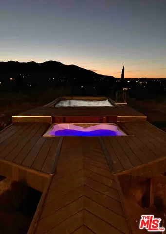 a small white house with a small yard and mountain view