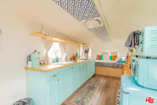 a kitchen with sink cabinets and wooden floor