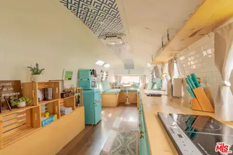 a living room with lots of furniture and a wooden floor