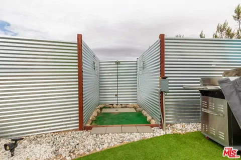 a view of a chairs in a back yard