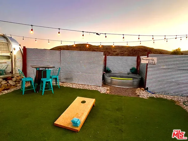 a view of a backyard with furniture and garden