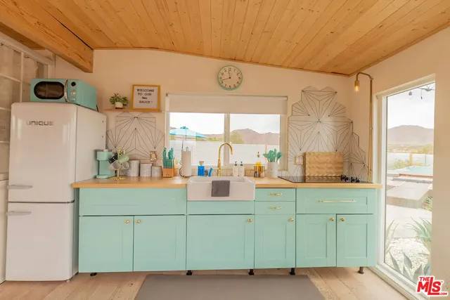 a dining room with furniture and a large window