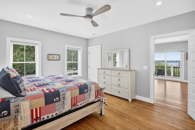 a bedroom with a large bed and a dresser