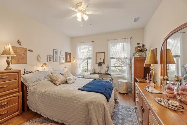 a bedroom with a bed a couch and dresser