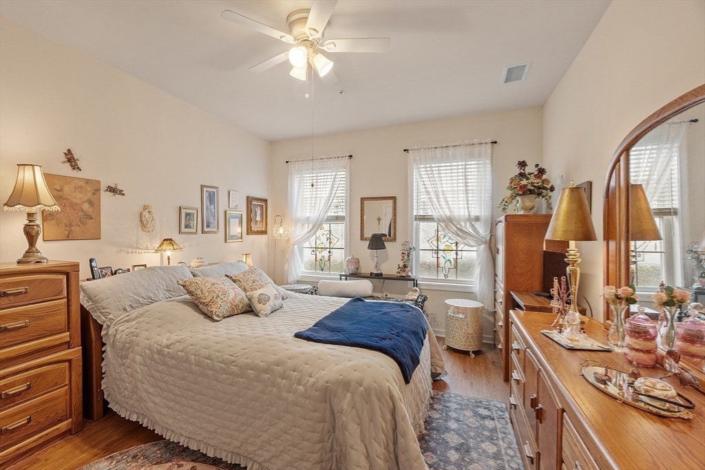 200 Martins Landing, Unit 102 North Reading, MA 01864 - Photo 19 of 33 a bedroom with a bed a couch and dresser