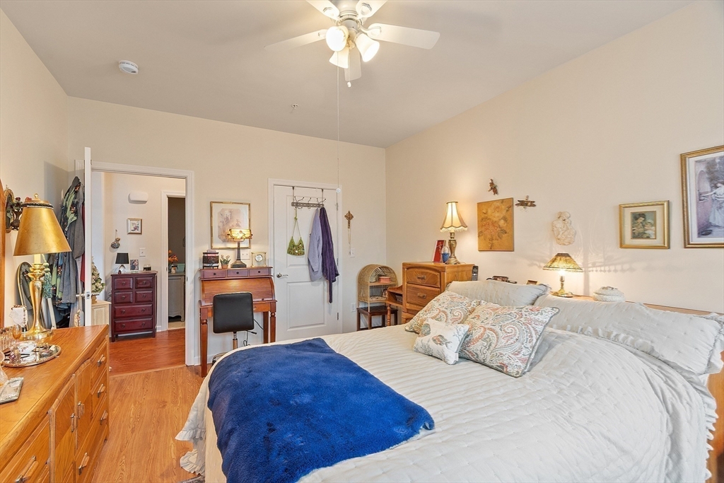 200 Martins Landing, Unit 102 North Reading, MA 01864 - Photo 20 of 33 a bedroom with a bed and a chandelier