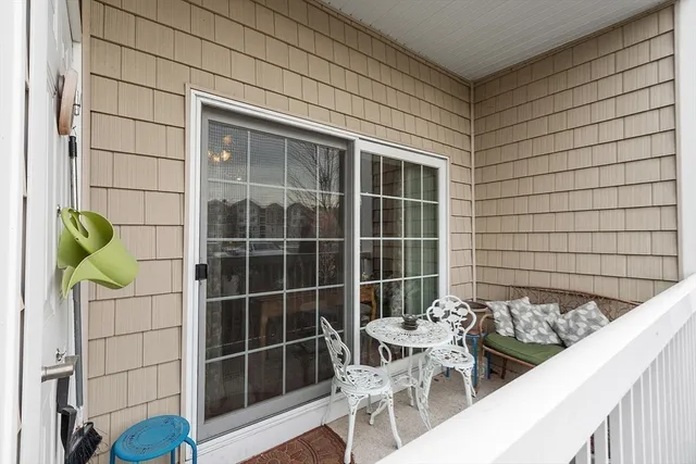 a view of a door and chair and table in front of house