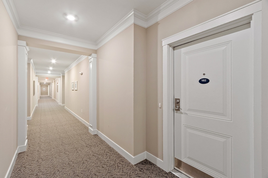 200 Martins Landing, Unit 102 North Reading, MA 01864 - Photo 27 of 33 a view of a hallway with wooden floor