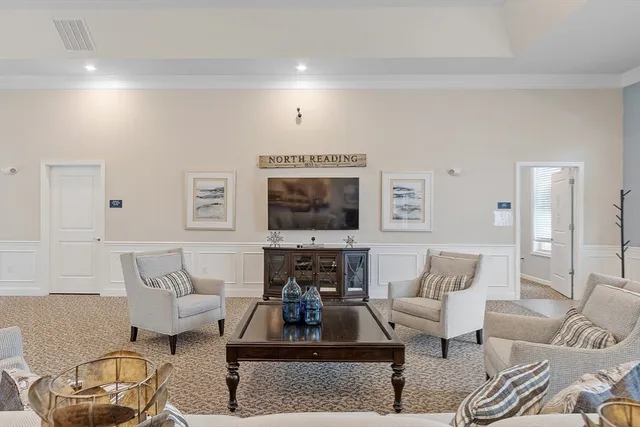 a front view of a house with garden and trees