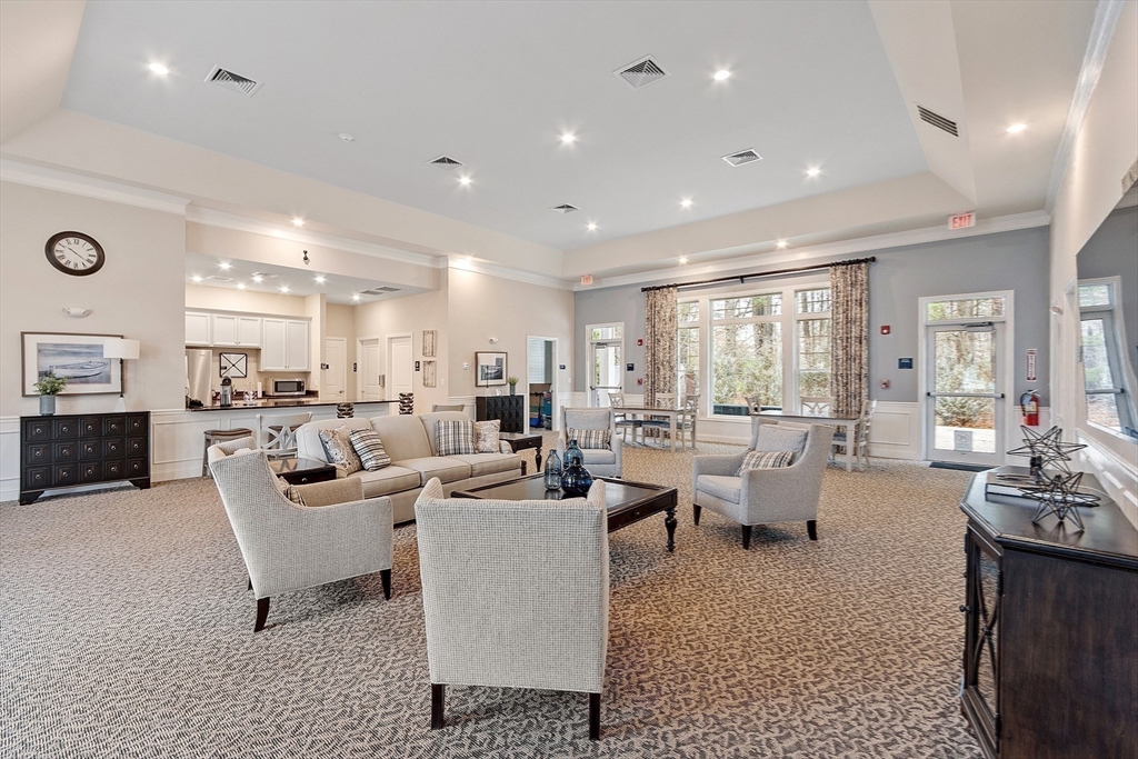 200 Martins Landing, Unit 102 North Reading, MA 01864 - Photo 31 of 33 a living room with lots of furniture and a wooden floor