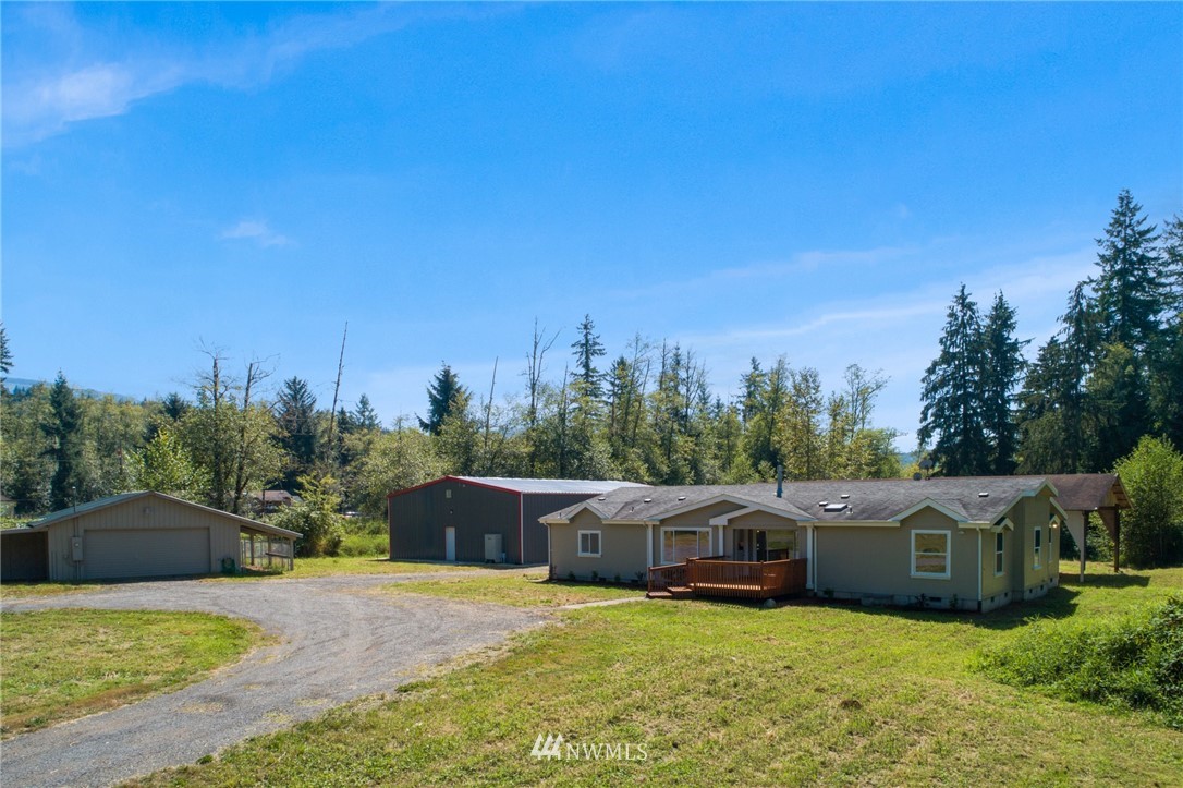 29122 Cedar Ponds Road Monroe, WA 98272 - Photo 1 of 25 a view of a house with yard and trees in the background
