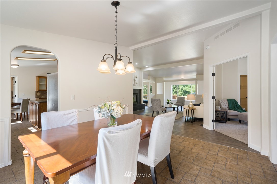 29122 Cedar Ponds Road Monroe, WA 98272 - Photo 11 of 25 a view of a dining room and livingroom furniture a chandelier and wooden floor