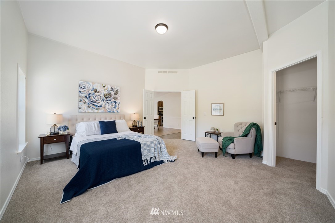 29122 Cedar Ponds Road Monroe, WA 98272 - Photo 12 of 25 a spacious bedroom with a bed a table and chair