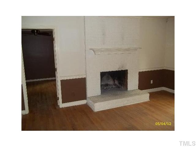 7004 Sandringham Drive Raleigh, NC 27613 - Photo 2 of 8 a open kitchen with a fireplace