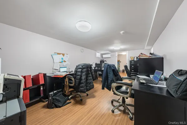 a view of a workspace with furniture and wooden floor
