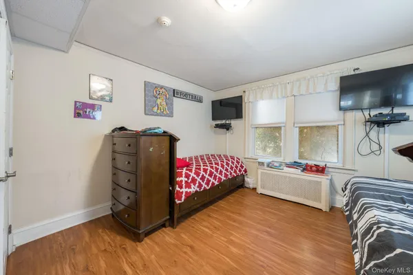 a bedroom with furniture and a flat screen tv