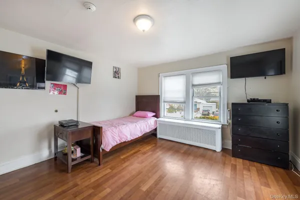 a bedroom with a bed and flat screen tv