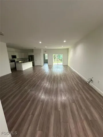 a view of an empty room and wooden floor