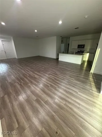 an empty room with wooden floor