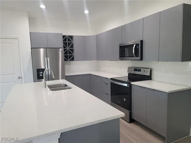 a kitchen that has a sink and a stove in it