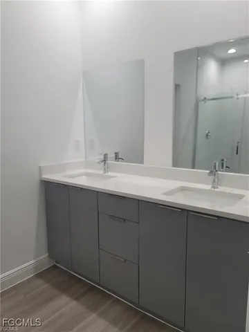 a bathroom with a double vanity sink and mirror