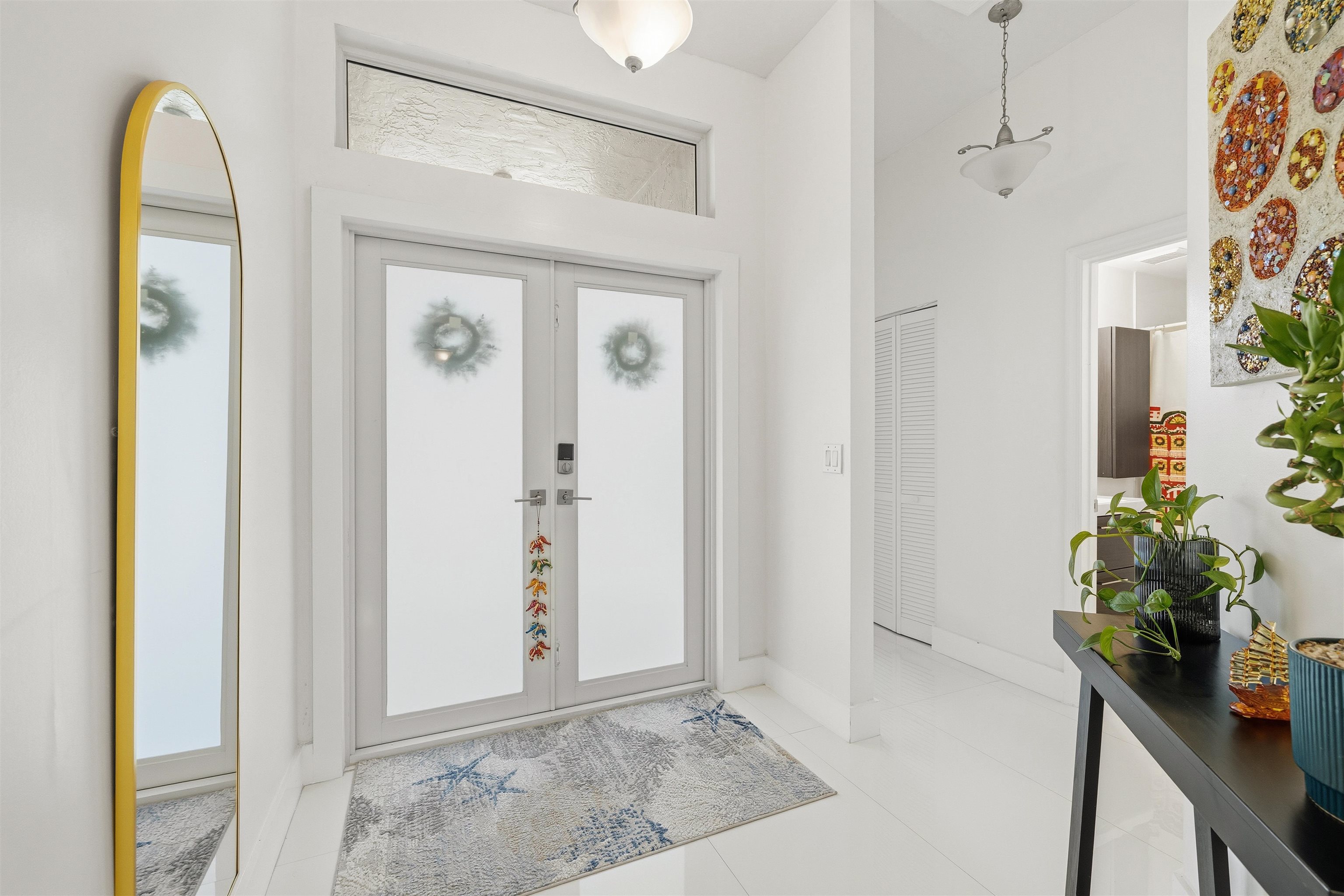 75 Gables Boulevard Weston, FL 33326 - Photo 11 of 29 Foyer entrance featuring french doors, light tile patterned floors, and a high ceiling