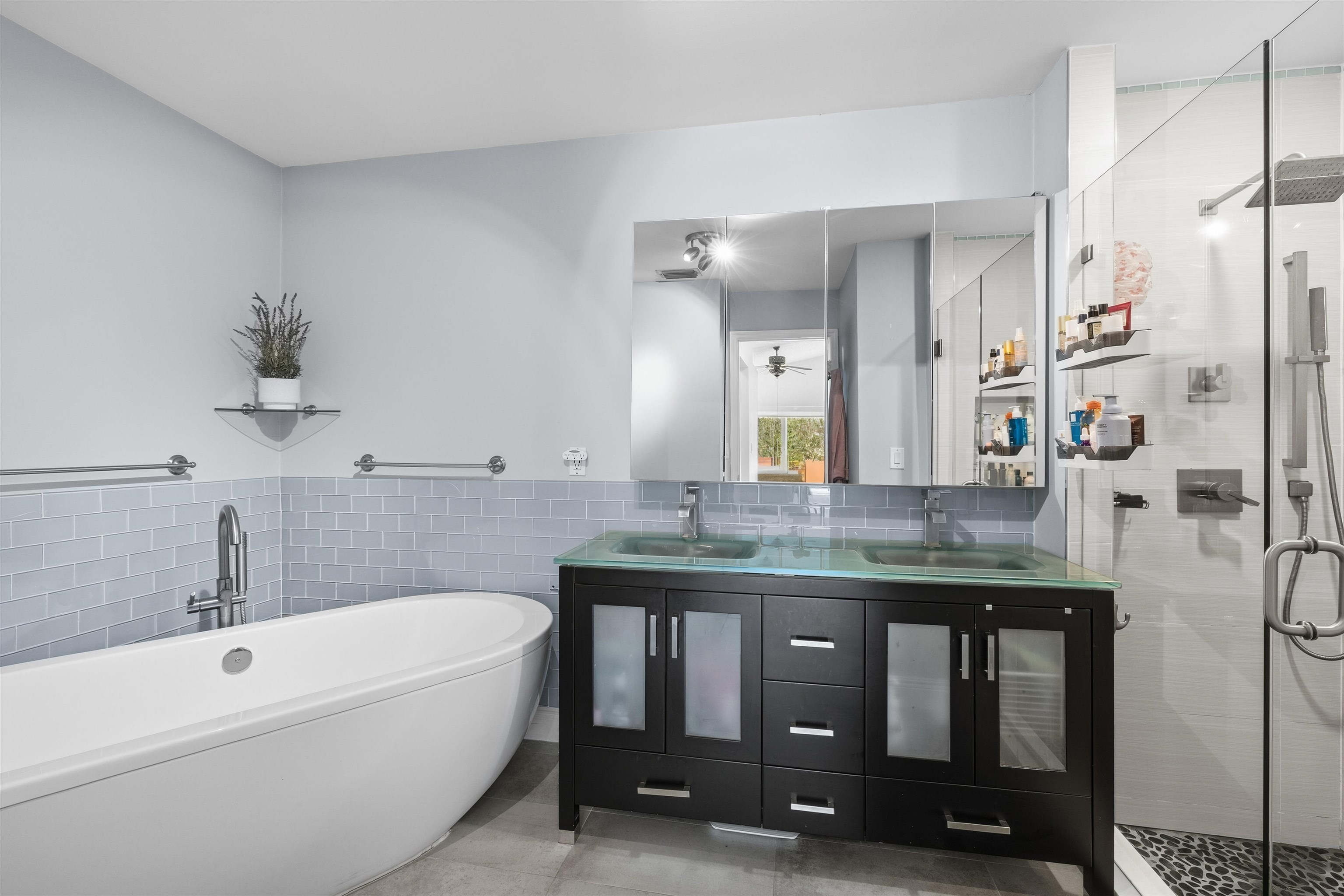 75 Gables Boulevard Weston, FL 33326 - Photo 15 of 29 Bathroom featuring tile walls, double vanity, a stall shower, a freestanding bath, and wainscoting