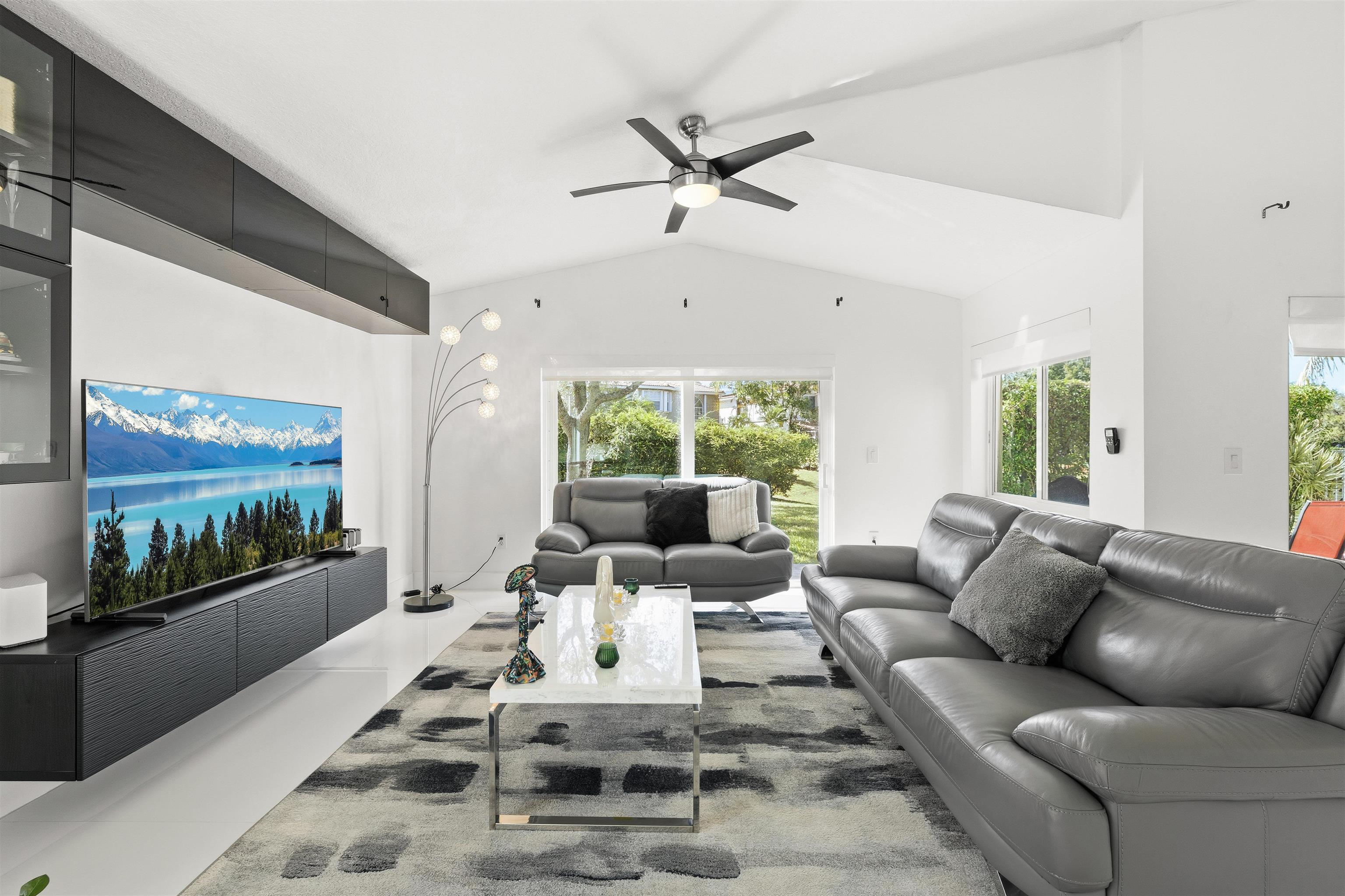 75 Gables Boulevard Weston, FL 33326 - Photo 2 of 29 Living area featuring lofted ceiling and ceiling fan