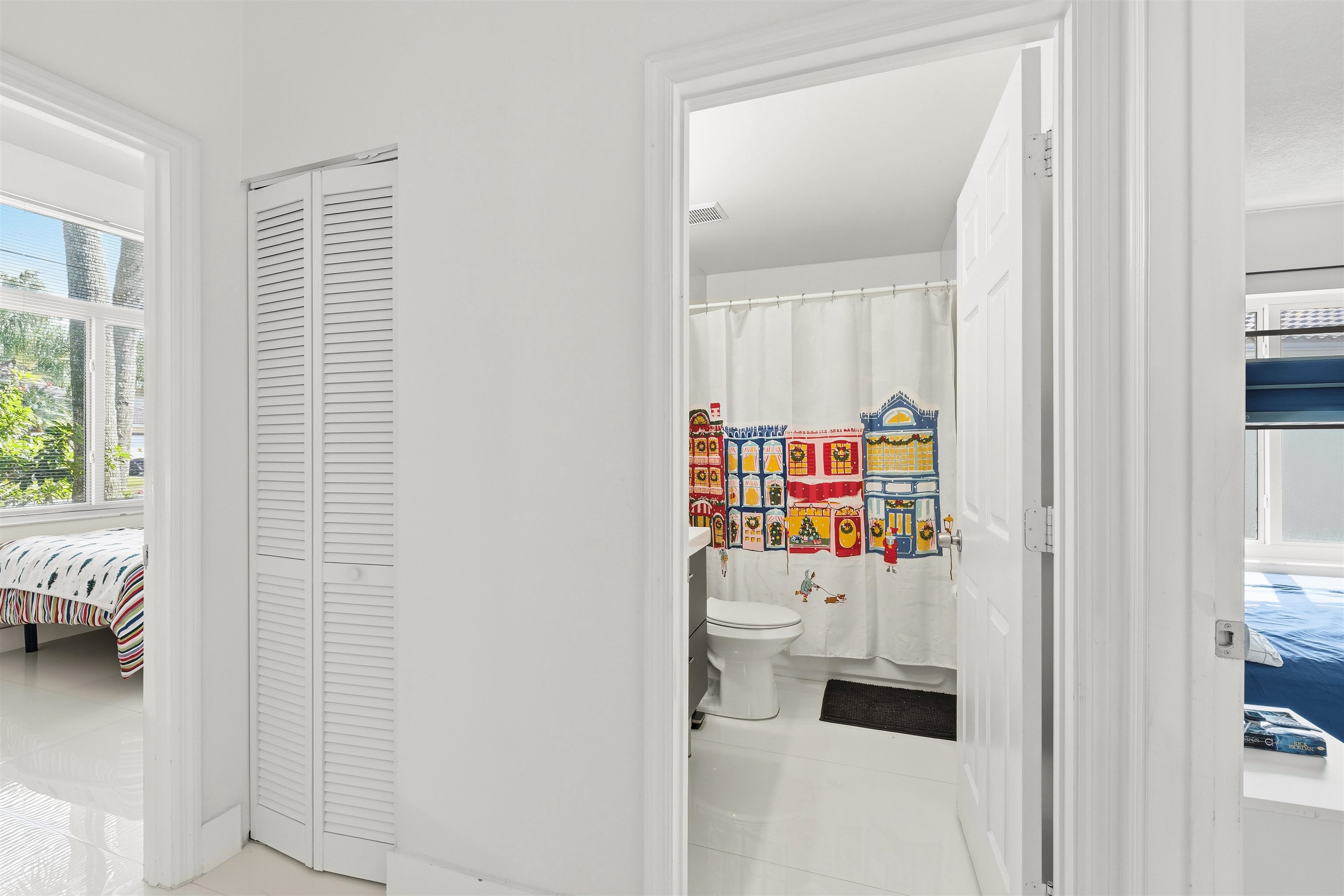 75 Gables Boulevard Weston, FL 33326 - Photo 20 of 29 Bathroom featuring plenty of natural light, connected bathroom, a closet, and curtained shower