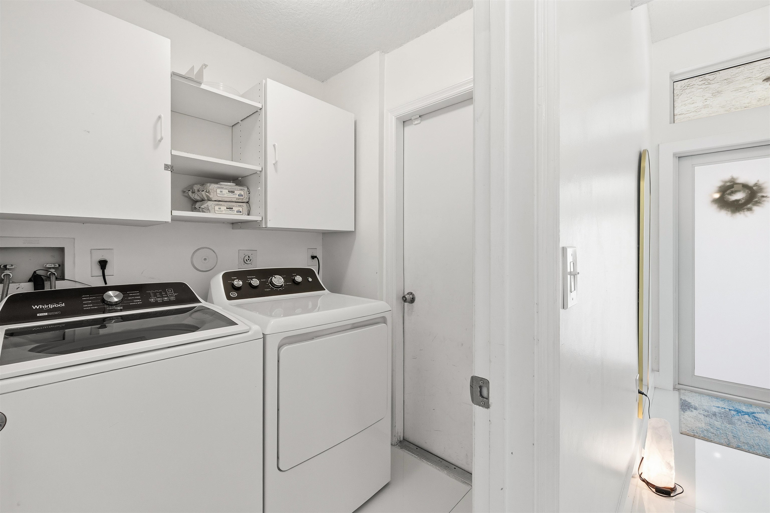 75 Gables Boulevard Weston, FL 33326 - Photo 21 of 29 Laundry area featuring washing machine and clothes dryer and cabinet space