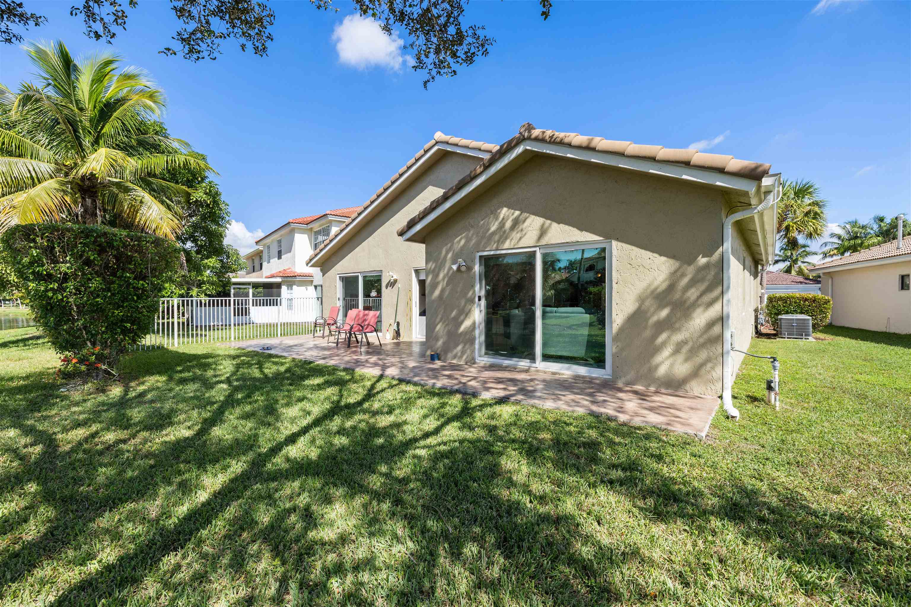 75 Gables Boulevard Weston, FL 33326 - Photo 22 of 29 Back of property with stucco siding, a patio, and a tiled roof