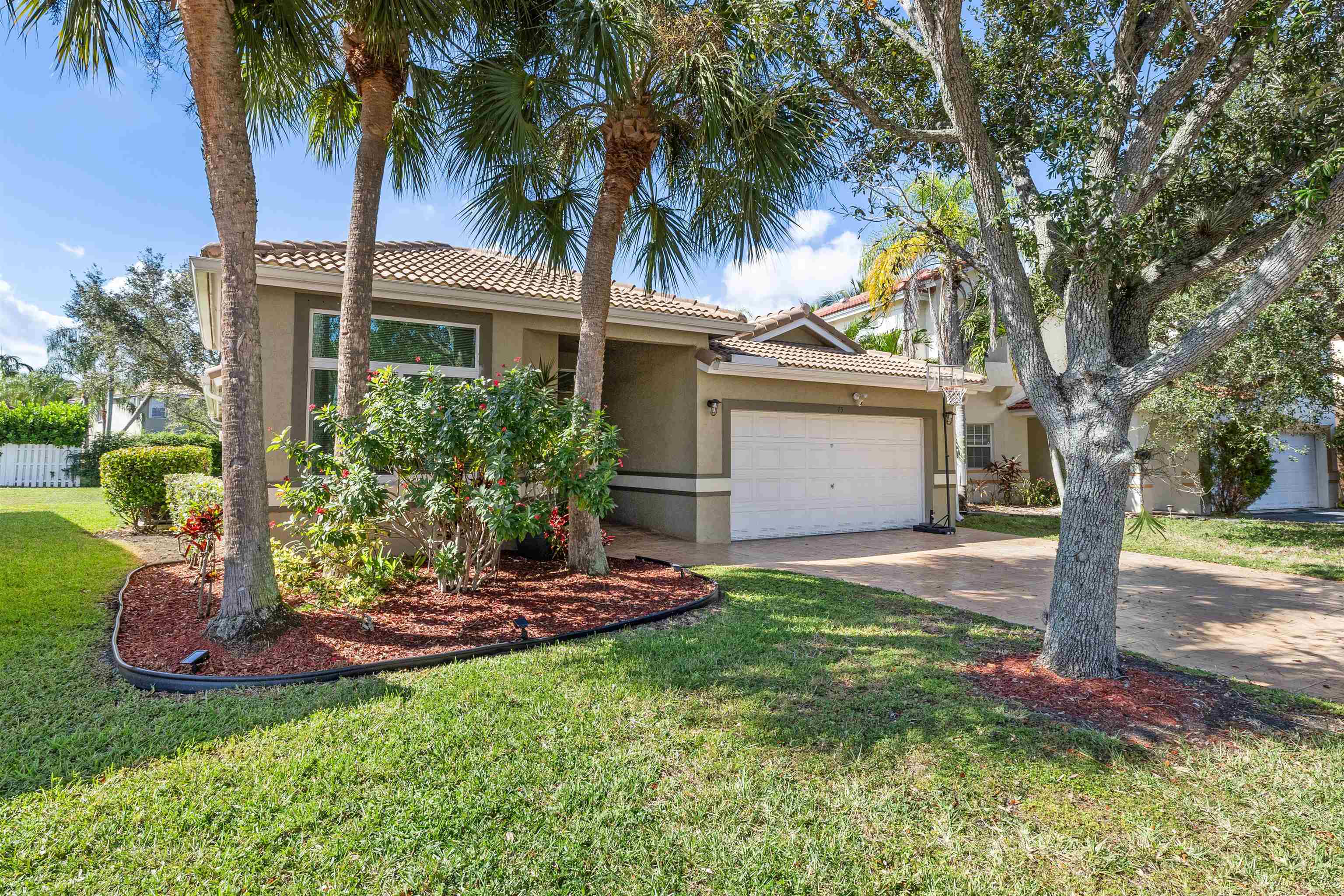 75 Gables Boulevard Weston, FL 33326 - Photo 24 of 29 View of front of home with stucco siding, a front yard, driveway, and a tiled roof