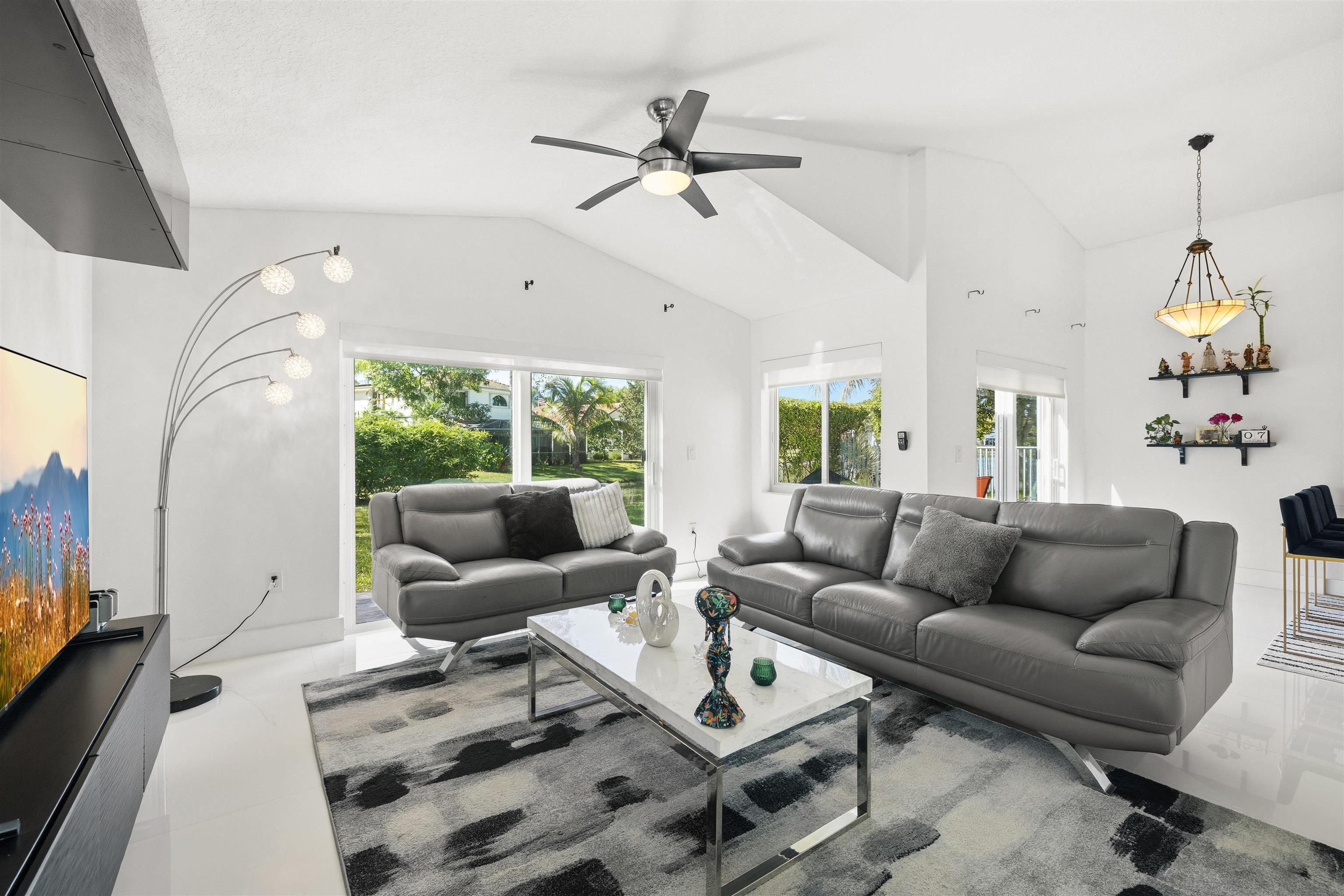 75 Gables Boulevard Weston, FL 33326 - Photo 3 of 29 Living area featuring vaulted ceiling and ceiling fan