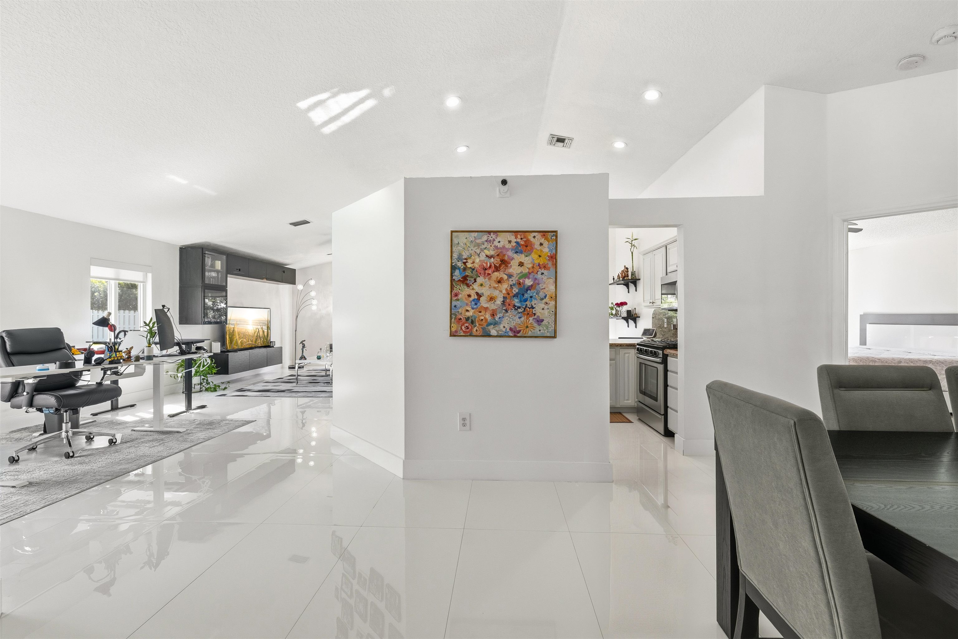75 Gables Boulevard Weston, FL 33326 - Photo 5 of 29 Dining area with a desk, light tile patterned flooring, and lofted ceiling