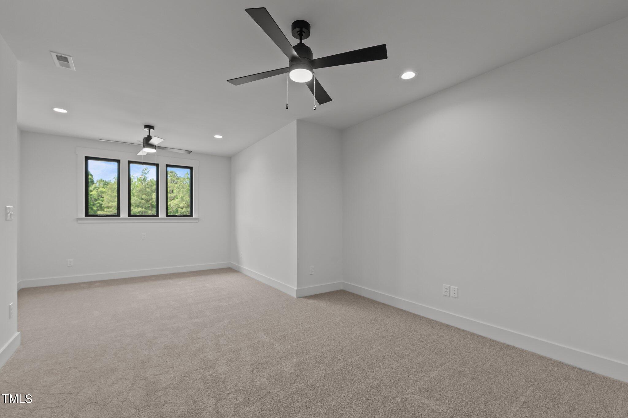 200 Broadleaf Lane Louisburg, NC 27549 - Photo 37 of 57 an empty room with a window and a ceiling fan