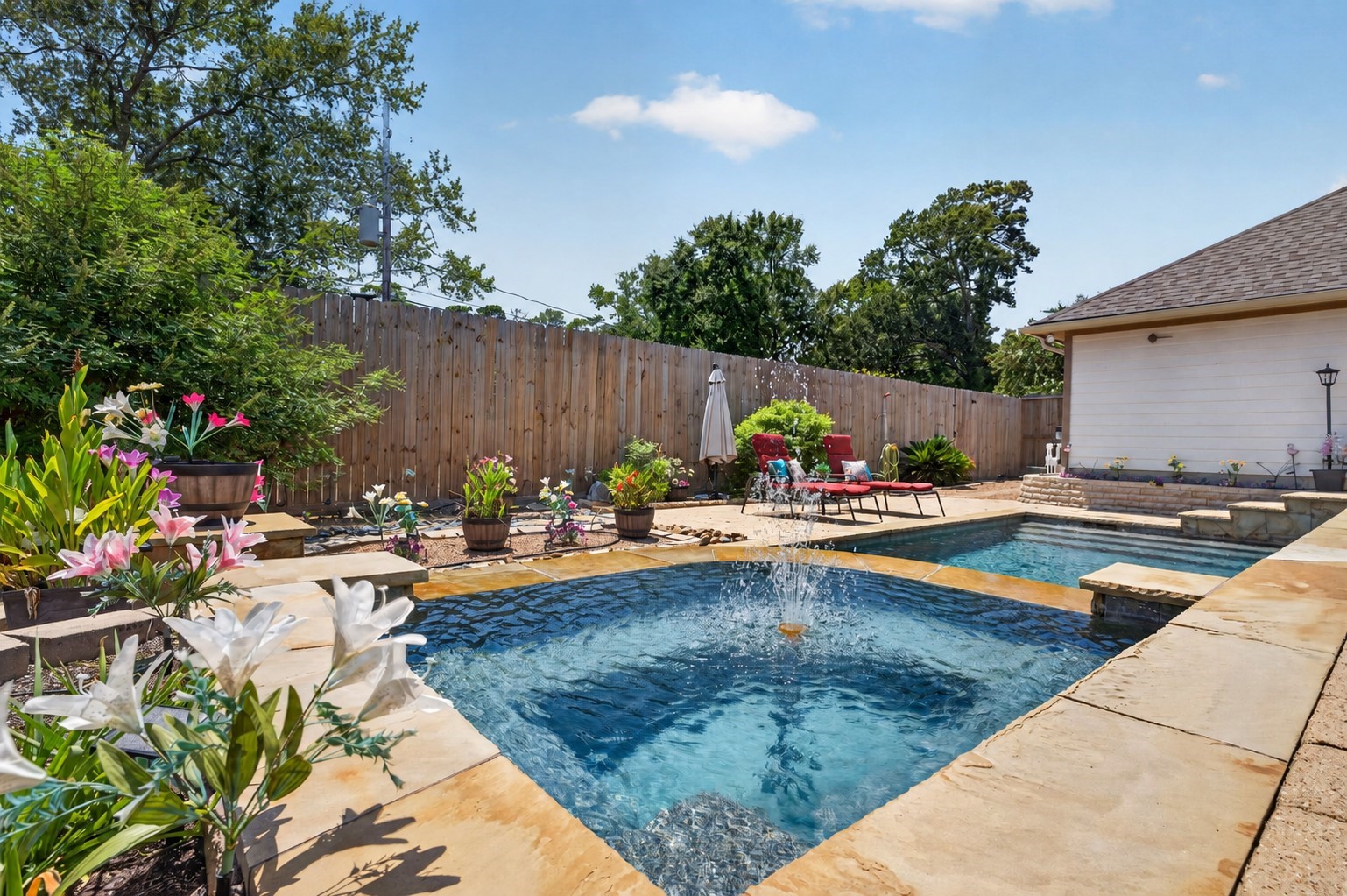 514 Oak Ridge Grove Circle Spring, TX 77386 - Photo 34 of 35 Water features add movement and sound to the pool, while the eight-foot privacy fence, installed in 2024, and no back neighbors create a more secluded setting.