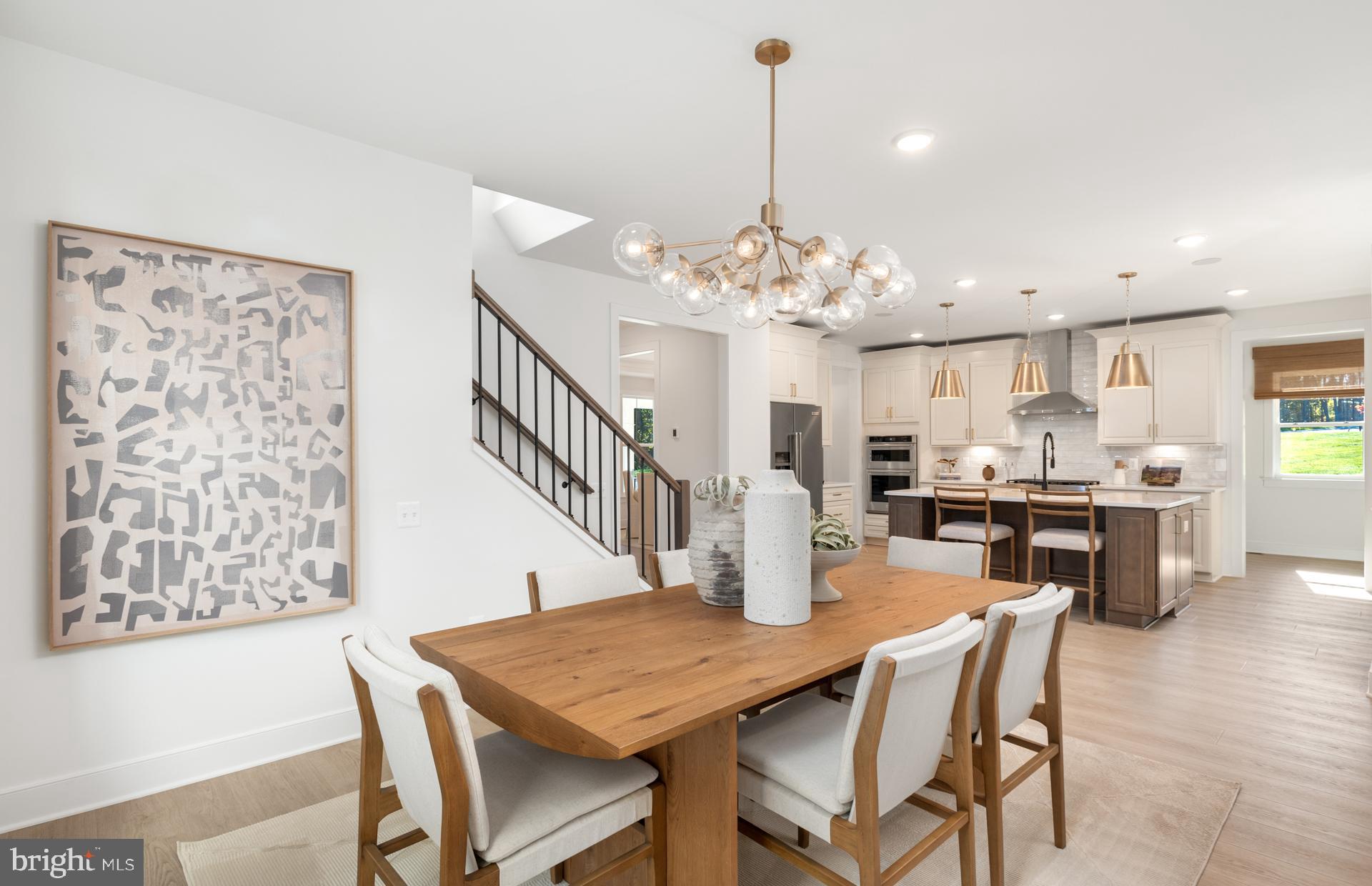 18279 Cresswell Rst Lane Leesburg, VA 20176 - Photo 12 of 60 a dining room with wooden floor a chandelier a wooden table and chairs
