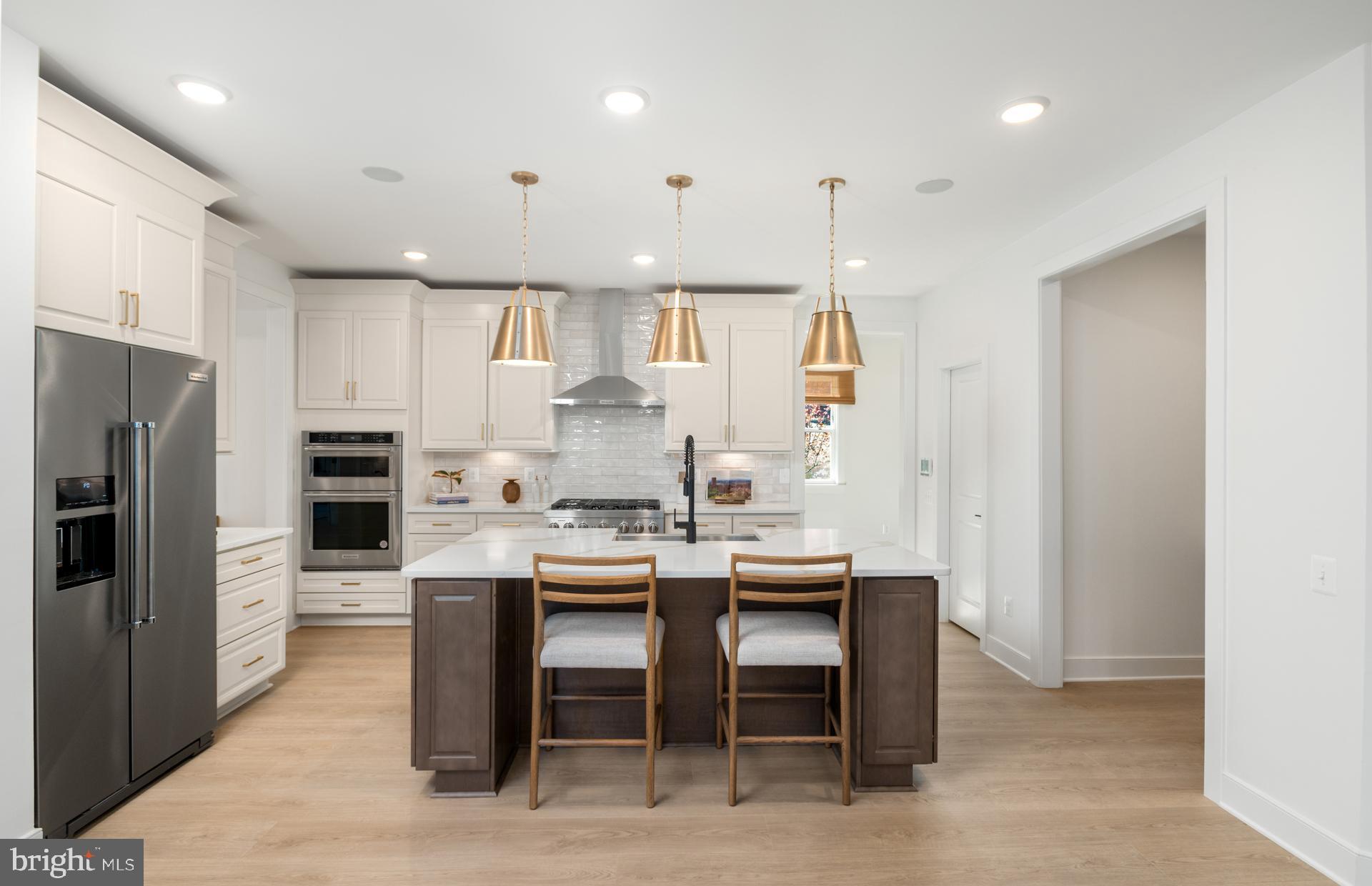 18279 Cresswell Rst Lane Leesburg, VA 20176 - Photo 19 of 60 a kitchen with stainless steel appliances kitchen island granite countertop a refrigerator and a stove top oven