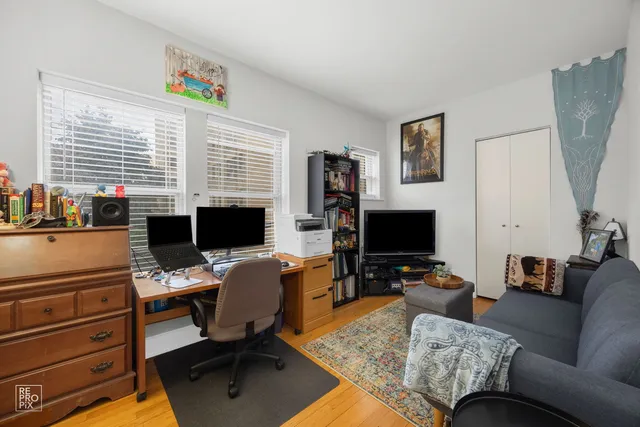 a view of a workspace with furniture and a window