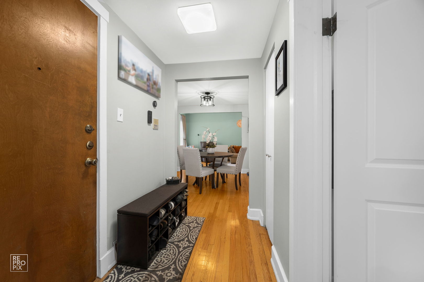853 West Carmen Avenue, Unit 2D Chicago, IL 60640 - Photo 3 of 22 a dining room with furniture and a chandelier