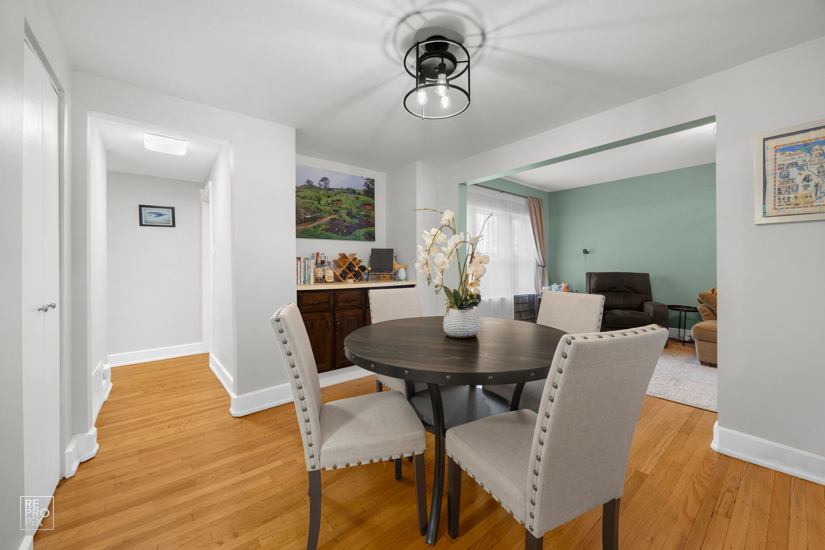 853 West Carmen Avenue, Unit 2D Chicago, IL 60640 - Photo 7 of 22 a view of a dining room with furniture and wooden floor