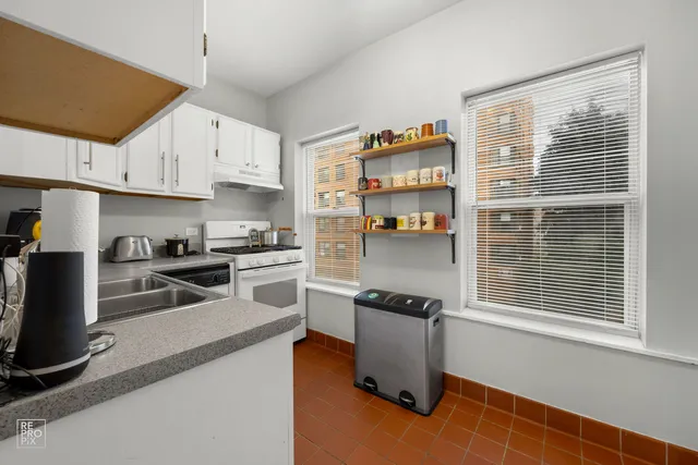 a kitchen with stainless steel appliances granite countertop a stove and a refrigerator
