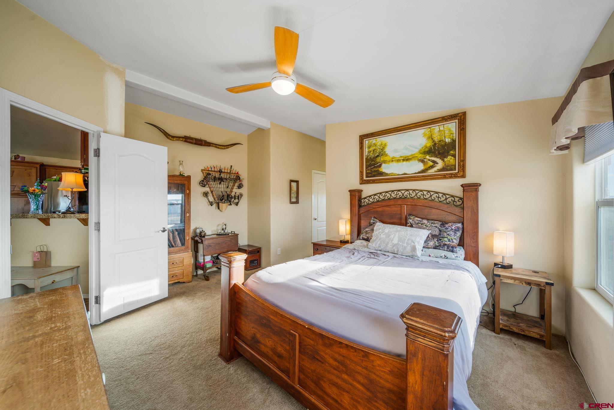 75 Sundial Lane Ignacio, CO 81137 - Photo 14 of 31 a bedroom with a bed and a chandelier